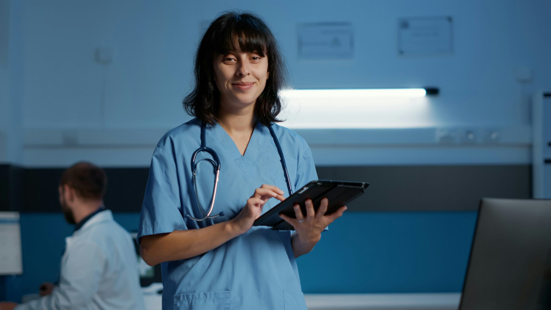 Woman healthcare worker holding an iPad,